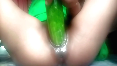 Indian solo female uses a cucumber to rub her clit