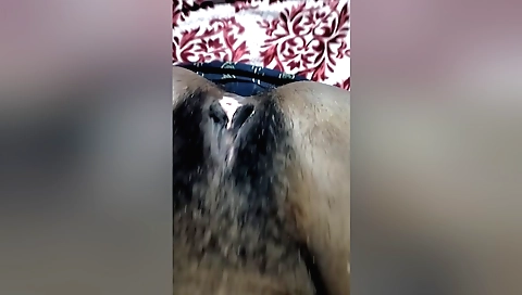 Indian woman masturbates with a dildo in her hairy pussy