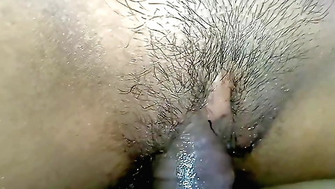 Hairy brunette is playing with a toy in her vagina