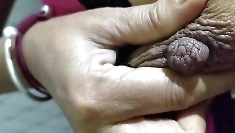 Indian babe licks her shaved pussy in the standing position