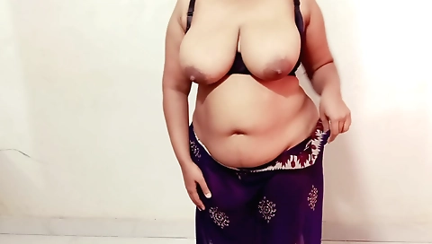 Busty brunette with big boobs fucking herself in bed