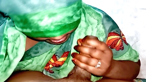 A woman is giving her stepson a handjob and a blowjob